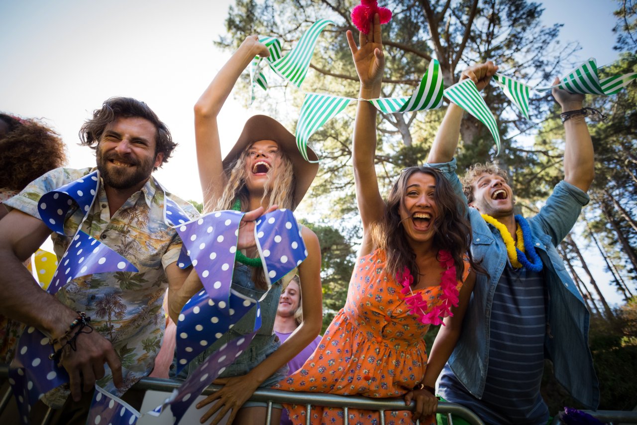 Group of friends dancing at music festival